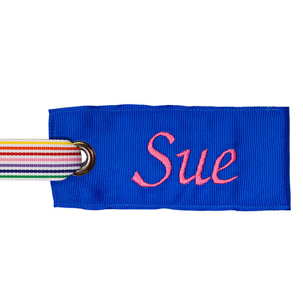 Rainbow strip handle on blue luggage tag with pink text