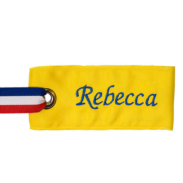 Bright yellow bag tag with personalized name