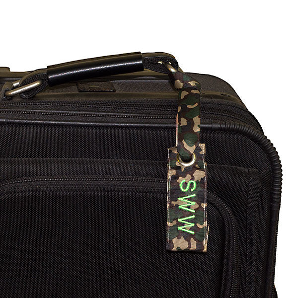 mini camo luggage tag shown on suitcase