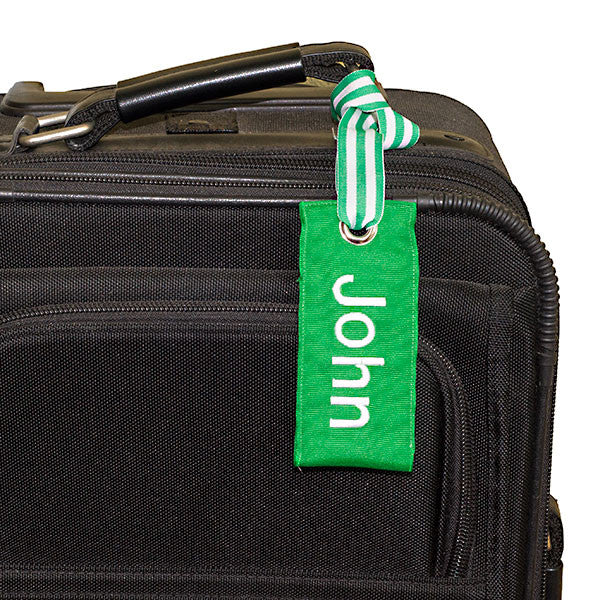 personalized green luggage tag shown on suitcase