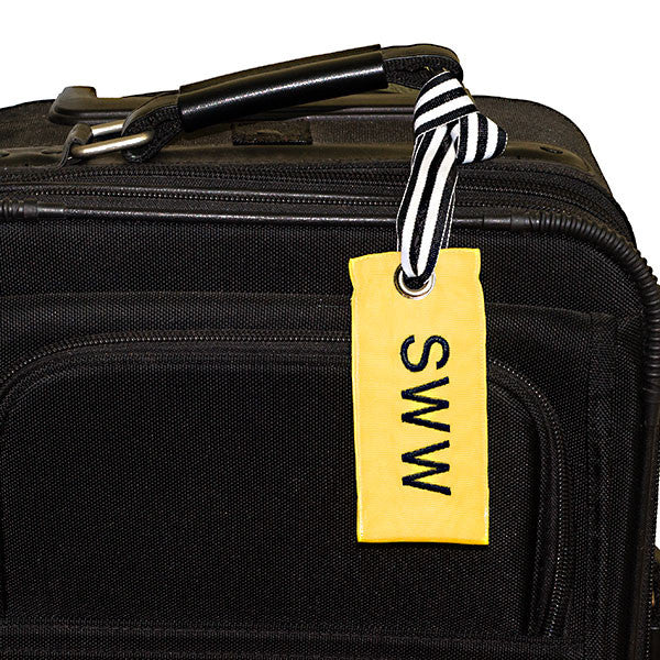 Sunny yellow custom luggage tag shown on suitcase