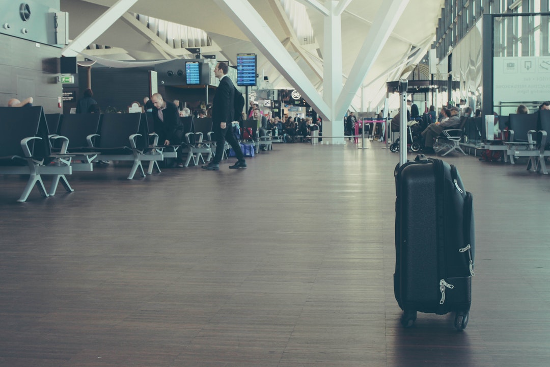Suitcase in airport - luggage tag info