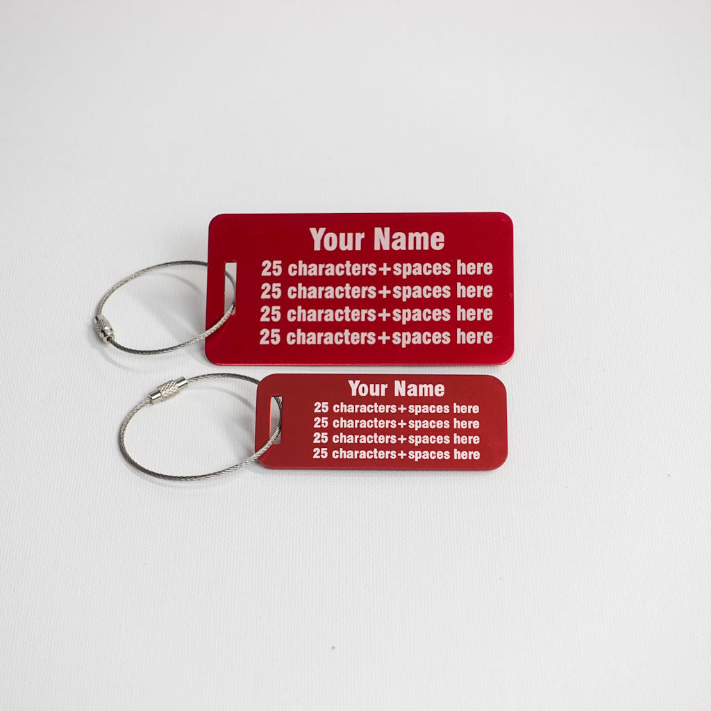 Two red aluminum luggage tags with sample text
