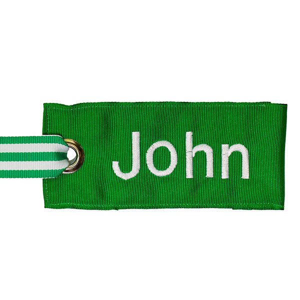 green fabric bag tag with white text from YourBagTag