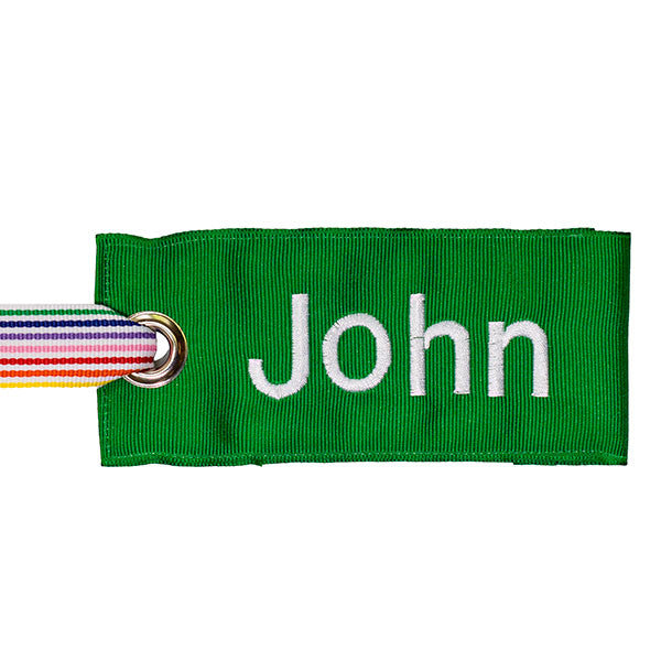 green luggage tag with rainbow stripe fabric handle