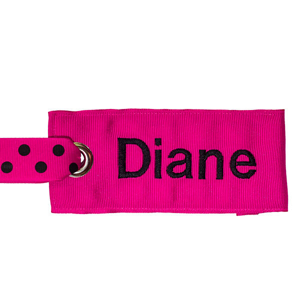 pink luggage tag with black text from YourBagTag