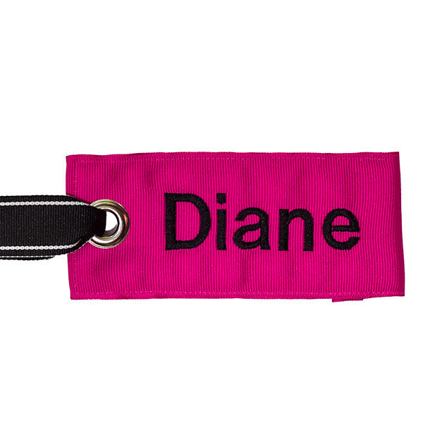 personalized pink bag tag with black text from YourBagTag