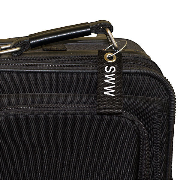 black mini extreme luggage tag shown on suitcase
